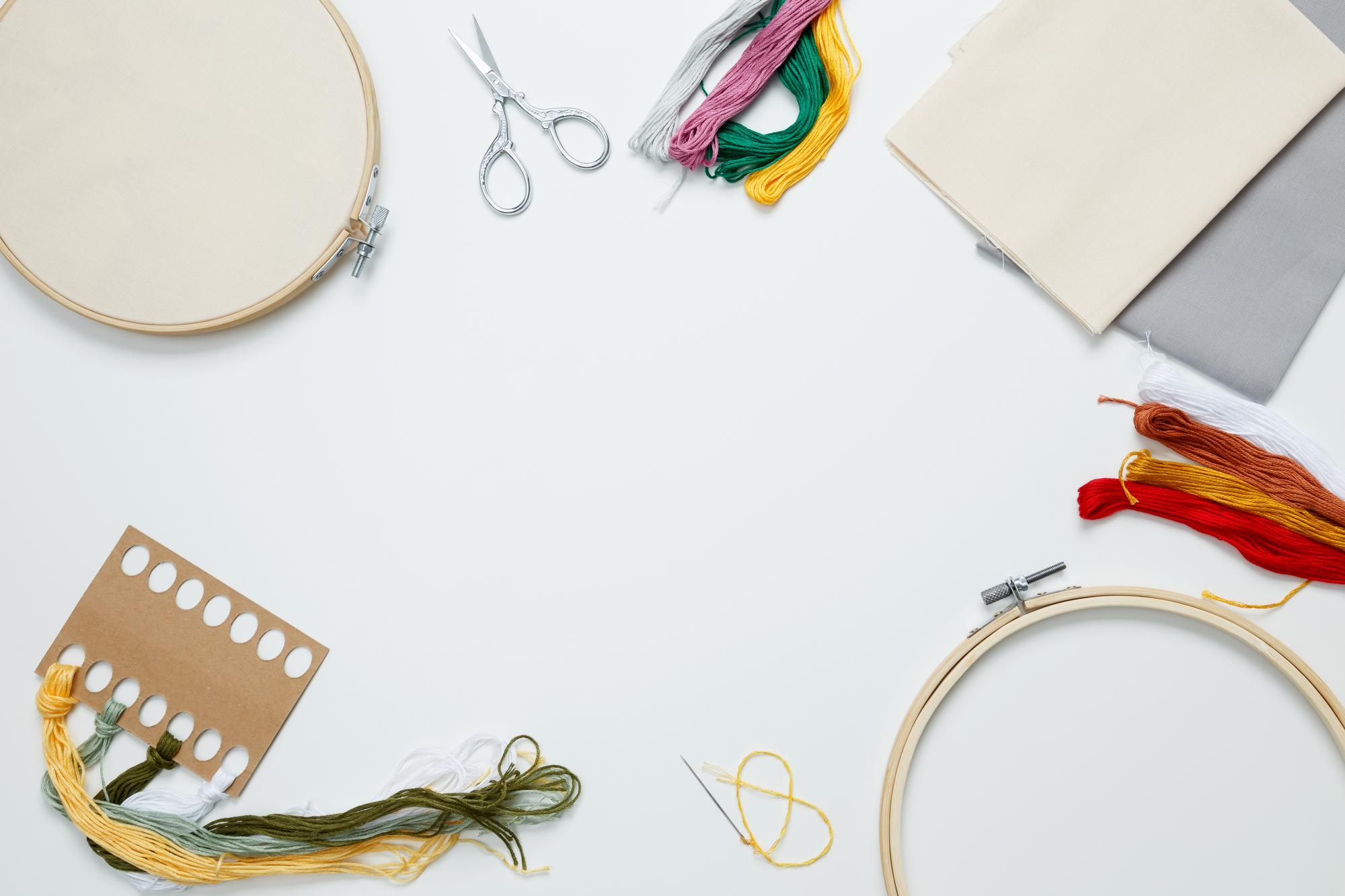 workshop table with threads and embroidery hoop